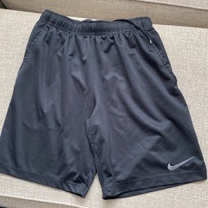 Two pairs of black Nike athletic shorts.